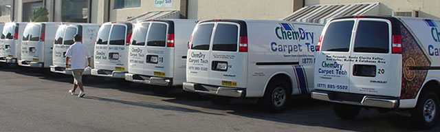 A fleet of Chem-Dry vans line up outside Chem-Dry Carpet Tech.
