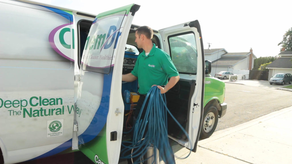 Chem-Dry floor cleaning franchise technician getting equipment out of van