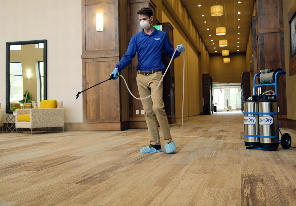 ChemDry employee spray hardwood floor how to start a cleaning business