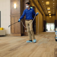 ChemDry employee spray hardwood floor