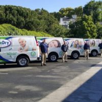 Chem-Dry franchise franchisees standing with Chem-Dry vans