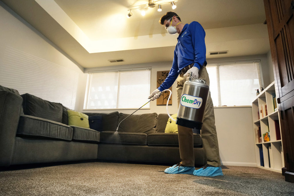 Chem-Dry franchise owner cleans carpet in a living room / build revenue
